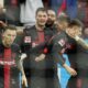 Leverkusen's Patrik Schick, center, celebrates after scoring the decisive goal during the German Bundesliga soccer match between Bayer Leverkusen and TSG Hoffenheim at the BayArena in Leverkusen, Germany, Saturday, March 30, 2024. (AP Photo/Martin Meissner)