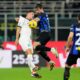 Napoli's Giacomo Raspadori, left, jumps for the ball with Inter Milan's Francesco Acerbi during the Serie A soccer match between Inter Milan and Napoli at the San Siro Stadium, in Milan, Italy, Sunday, March 17, 2024. (AP Photo/Antonio Calanni)