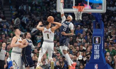 Denver Nuggets forward Michael Porter Jr. (1) drives to shoot against Dallas Mavericks center Daniel Gafford (21) as Mavericks' guard Luka Doncic (77) and Nuggets' center Nikola Jokic look on during the first half of an NBA basketball game in Dallas, Sunday, March 17, 2024. (AP Photo/LM Otero)