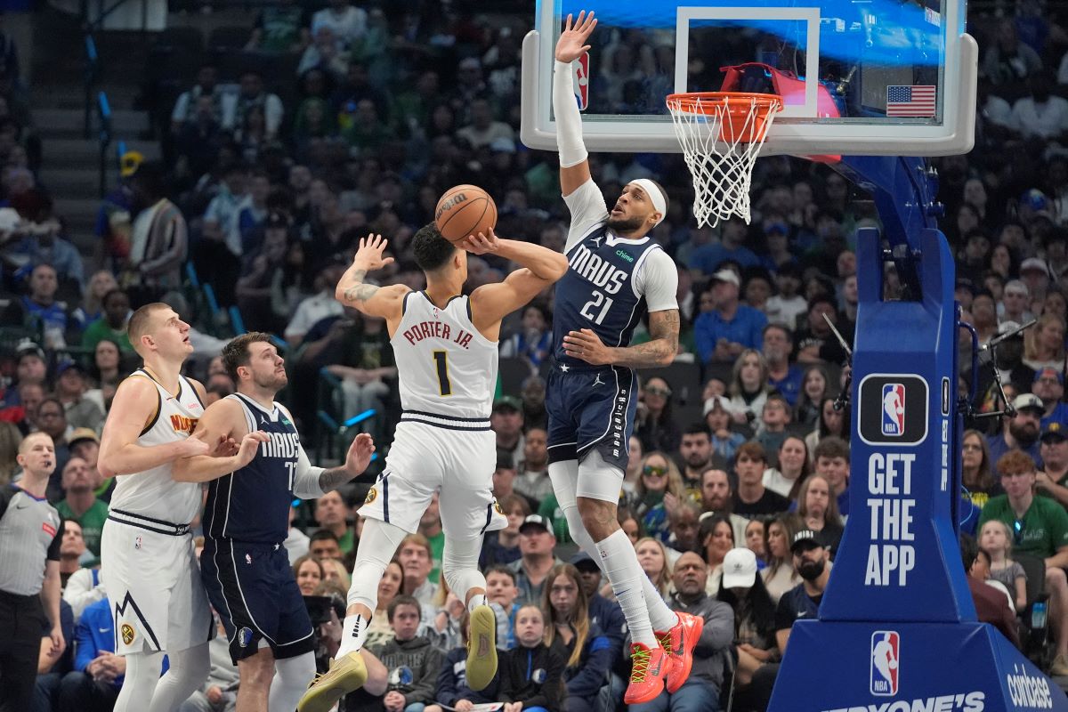 Denver Nuggets forward Michael Porter Jr. (1) drives to shoot against Dallas Mavericks center Daniel Gafford (21) as Mavericks' guard Luka Doncic (77) and Nuggets' center Nikola Jokic look on during the first half of an NBA basketball game in Dallas, Sunday, March 17, 2024. (AP Photo/LM Otero)