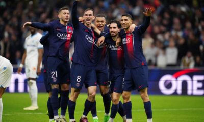 PSG's Vitinha, second from right, celebrates with teammate after he scored his side's first goal during the French League One soccer match between Marseille and Paris at the Velodrome stadium in Marseille, south of France, Sunday, March 31, 2024. (AP Photo/Daniel Cole)