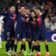 PSG's Vitinha, second from right, celebrates with teammate after he scored his side's first goal during the French League One soccer match between Marseille and Paris at the Velodrome stadium in Marseille, south of France, Sunday, March 31, 2024. (AP Photo/Daniel Cole)