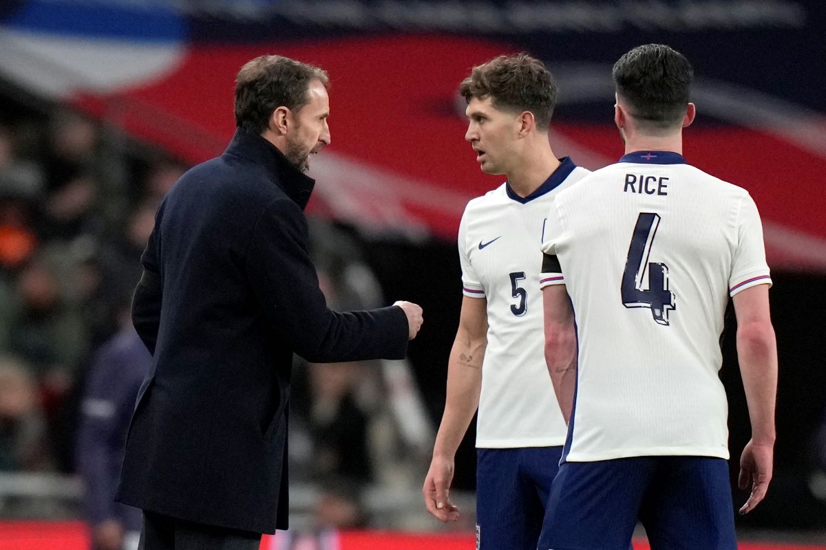 England coach Gareth Southgate speaks to England's John Stones during a friendly soccer match between England and Brazil at Wembley Stadium in London, Saturday, March 23, 2024. (AP Photo/Alastair Grant)