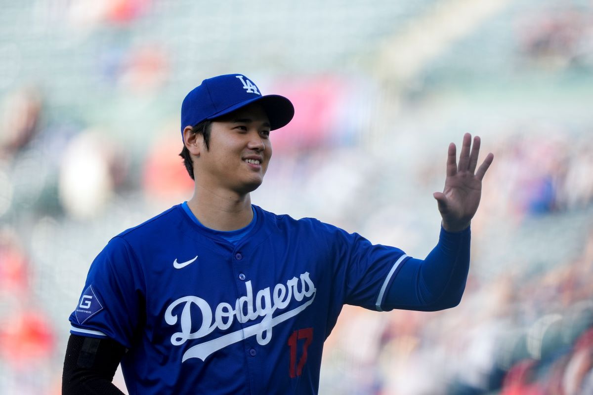 Los Angeles Dodgers designated hitter Shohei Ohtani warms up before an exhibition baseball game against the Los Angeles Angels, Tuesday, March 26, 2024, in Anaheim, Calif. (AP Photo/Ryan Sun)