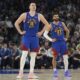 Denver Nuggets center Nikola Jokic (15) and guard Jamal Murray (27) stand on the court during the second half of an NBA basketball game against the Minnesota Timberwolves, Tuesday, March 19, 2024, in Minneapolis. (AP Photo/Abbie Parr)