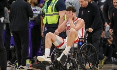 Houston Rockets center Alperen Sengun is wheeled from the arena in a wheel chair during the second half of an NBA basketball game against the Sacramento Kings in Sacramento, Calif., Sunday, March 10, 2024. (AP Photo/Randall Benton)