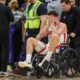 Houston Rockets center Alperen Sengun is wheeled from the arena in a wheel chair during the second half of an NBA basketball game against the Sacramento Kings in Sacramento, Calif., Sunday, March 10, 2024. (AP Photo/Randall Benton)