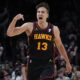 Atlanta Hawks guard Bogdan Bogdanovic (13) reacts after a basket during the second half of an NBA basketball game against the Boston Celtics Thursday, March 28, 2024, in Atlanta. (AP Photo/John Bazemore)