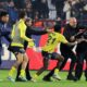 A Trabzonspor supporter, right, confronts Fenerbahce's players during clashes at the end of Turkish Super Lig soccer match between Trabzonspor and Fenerbahce at the Senol Gunes stadium in Trabzon, Turkey, Sunday, March 17, 2024. Clashes erupted between Trabzonspor fans and Fenerbahce players after local supporters stormed in the pitch at the end of the Turkish Super Lig match. (Huseyin Yavuz/Dia Images via AP)