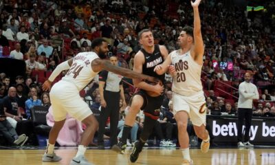 Cleveland Cavaliers forward Marcus Morris Sr. (24) and forward Georges Niang (20) defend Miami Heat forward Nikola Jovic (5) during the second half of an NBA basketball game, Sunday, March 24, 2024, in Miami. (AP Photo/Marta Lavandier)