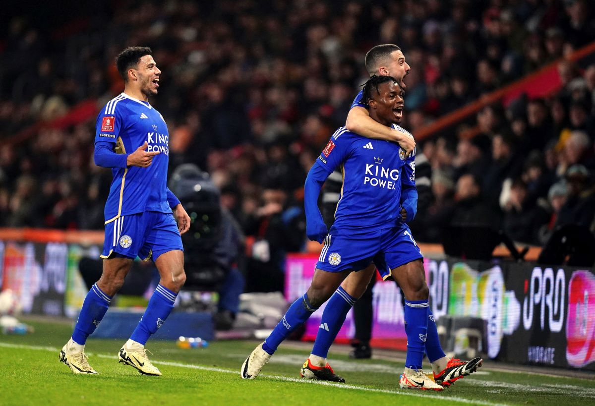 Leicester City's Abdul Fatawu, right, celebrates with Conor Coady and and James Justin, left, after scoring the opening goal during the FA Cup 5th round soccer match at the Vitality stadium in Bournemouth, England, Tuesday, Feb. 27, 2024. (John Walton/PA via AP)