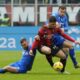AC Milan's Luka Jovic, centre, challenges for the ball with Empoli's Sebastian Walukiewicz, left, and Empoli's Szymon Zurkowski during a Serie A soccer match between AC Milan and Empoli at the San Siro stadium in Milan, Italy, Sunday, March 10, 2024. (AP Photo/Luca Bruno)