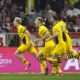 Dortmund's Julian Ryerson, left, celebrates after scoring his side's second goal during the German Bundesliga soccer match between FC Bayern Munich and Borussia Dortmund at the Allianz Arena stadium, in Munich, Germany, Saturday, March 30, 2024. (AP Photo/Matthias Schrader)