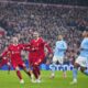 Liverpool's Alexis Mac Allister, left, celebrates after scoring a penalty, his side's first goal during the English Premier League soccer match between Liverpool and Manchester City, at Anfield stadium in Liverpool, England, Sunday, March 10, 2024. (AP Photo/Jon Super)