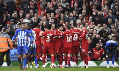 Liverpool players celebrate after Liverpool's Mohamed Salah scored his side's second goal during the English Premier League soccer match between Liverpool and Brighton and Hove at Anfield Stadium in Liverpool, England, Sunday, March 31, 2024. (AP Photo/Rui Vieira)
