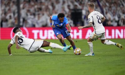 Leipzig's Lois Openda, centre, tries to dribble past Real Madrid's Aurelien Tchouameni, left, and Real Madrid's Toni Kroos during the Champions League round of 16 second leg soccer match between Real Madrid and RB Leipzig at the Santiago Bernabeu stadium in Madrid, Spain, Wednesday, March 6, 2024. (AP Photo/Manu Fernandez)