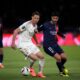 PSG's Marco Asensio, right, challenges Lyon's Nemanja Matic during the French League One soccer match between Paris Saint-Germain and Lyon at the Parc des Princes stadium in Paris, Sunday, April 21, 2024. (AP Photo/Christophe Ena)