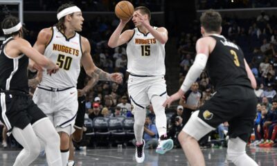 Denver Nuggets center Nikola Jokic (15) handles the ball in the second half of an NBA basketball game against the Memphis Grizzlies Sunday, April 14, 2024, in Memphis, Tenn. (AP Photo/Brandon Dill)