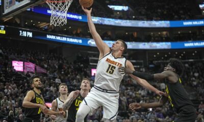 Denver Nuggets center Nikola Jokic (15) goes to the basket as Utah Jazz forward Taylor Hendricks, right, defends during the first half of an NBA basketball game Tuesday, April 9, 2024, in Salt Lake City. (AP Photo/Rick Bowmer)
