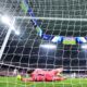 Barcelona's goalkeeper Marc-Andre ter Stegen fails to save the ball as Real Madrid's Vinicius Junior, right, celebrates after scoring his side's opening goal during the Spanish La Liga soccer match between Real Madrid and Barcelona at the Santiago Bernabeu stadium in Madrid, Spain, Sunday, April 21, 2024. (AP Photo/Manu Fernandez)
