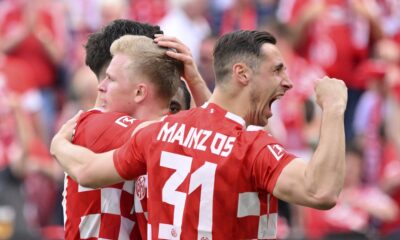 Mainz's scorer Jonathan Burkhardt, center, celebrate their side's first goal during the German Bundesliga soccer match between FSV Mainz 05 and TSG 1899 Hoffenheim in Mainz, Germany, Saturday, April 13, 2024. (Torsten Silz/dpa via AP)
