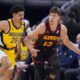 Indiana Pacers guard Ben Sheppard (26) defends Atlanta Hawks guard Bogdan Bogdanovic (13) during the first half of an NBA basketball game in Indianapolis, Sunday, April 14, 2024. (AP Photo/Michael Conroy)