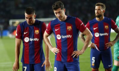 From left, Barcelona's Ferran Torres, Barcelona's Robert Lewandowski, Barcelona's Inigo Martinez react at the end of the Champions League quarterfinal second leg soccer match between Barcelona and Paris Saint-Germain at the Olimpic Lluis Companys stadium in Barcelona, Spain, Tuesday, April 16, 2024. (AP Photo/Joan Monfort)