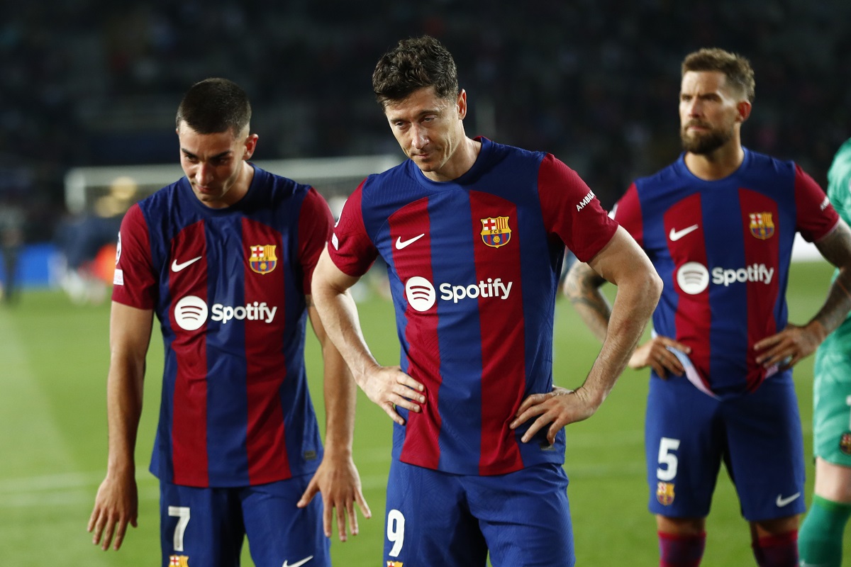 From left, Barcelona's Ferran Torres, Barcelona's Robert Lewandowski, Barcelona's Inigo Martinez react at the end of the Champions League quarterfinal second leg soccer match between Barcelona and Paris Saint-Germain at the Olimpic Lluis Companys stadium in Barcelona, Spain, Tuesday, April 16, 2024. (AP Photo/Joan Monfort)