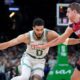 Boston Celtics forward Jayson Tatum (0) drives past Miami Heat forward Nikola Jovic (5) in the first half of Game 1 of an NBA basketball first-round playoff series, Sunday, April 21, 2024, in Boston. (AP Photo/Steven Senne)