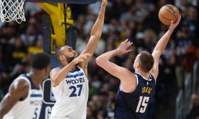 Denver Nuggets center Nikola Jokic, right, shoots against Minnesota Timberwolves center Rudy Gobert in the second half of an NBA basketball game Wednesday, April 10, 2024, in Denver. (AP Photo/David Zalubowski)