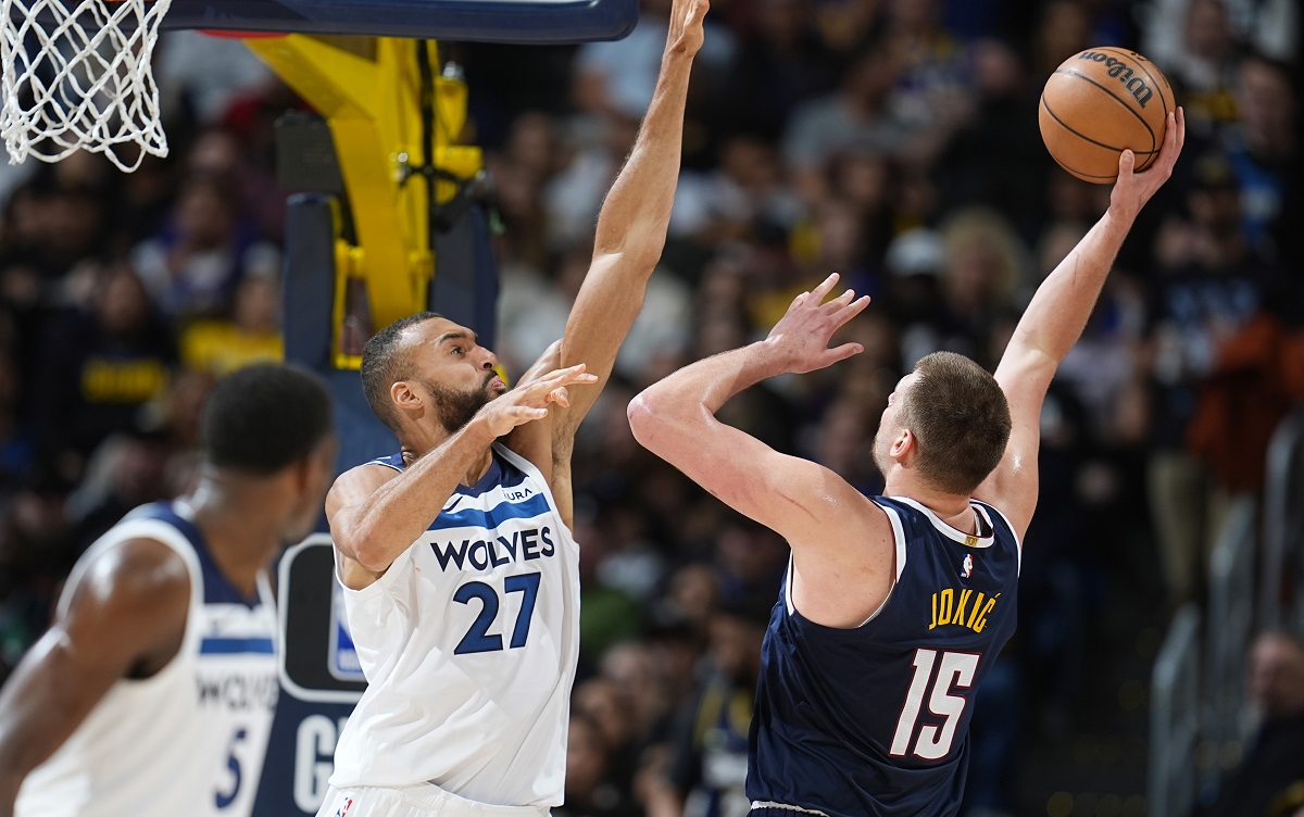 Denver Nuggets center Nikola Jokic, right, shoots against Minnesota Timberwolves center Rudy Gobert in the second half of an NBA basketball game Wednesday, April 10, 2024, in Denver. (AP Photo/David Zalubowski)