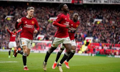 Manchester United's Kobbie Mainoo, centre, celebrates after scoring his side's second goal during the English Premier League soccer match between Manchester United and Liverpool at the Old Trafford stadium in Manchester, England, Sunday, April 7, 2024. (AP Photo/Dave Thompson)