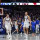 This handout photo provided by the Dallas Mavericks shows Dallas Mavericks guard Dante Exum (0) celebrating his last second three pointer with teammate Luka Doncic (77) as Houston Rockets defenders Reggie Bullock Jr. (25), Jabari Smith Jr. (10) and Jalen Green (4) look on at the end of the fourth quarter of an NBA basketball game Sunday, April 7, 2024 in Dallas. (Dallas Mavericks via AP)