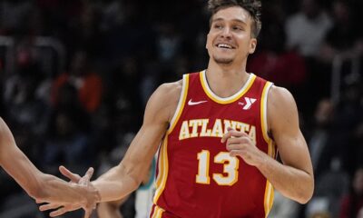 Atlanta Hawks guard Bogdan Bogdanovic (13) celebrates his three-point shot against the Charlotte Hornets during the first half of an NBA basketball game, Wednesday, April 10, 2024, in Atlanta. (AP Photo/Mike Stewart)