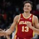 Atlanta Hawks guard Bogdan Bogdanovic (13) celebrates his three-point shot against the Charlotte Hornets during the first half of an NBA basketball game, Wednesday, April 10, 2024, in Atlanta. (AP Photo/Mike Stewart)