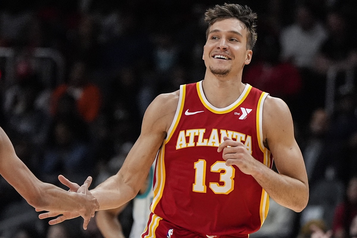 Atlanta Hawks guard Bogdan Bogdanovic (13) celebrates his three-point shot against the Charlotte Hornets during the first half of an NBA basketball game, Wednesday, April 10, 2024, in Atlanta. (AP Photo/Mike Stewart)
