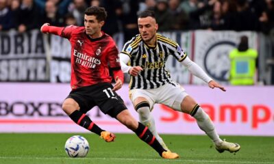 AC Milan's Christian Pulisic, left, and Juventus' Filip Kostic vie for the ball during a Serie A soccer match between Juventus and Milan at the Allianz Stadium in Turin, Italy, Saturday, April 27, 2024. (Marco Alpozzi/LaPresse via AP)