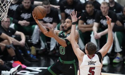 Boston Celtics forward Jayson Tatum (0) goes up for a shot against Miami Heat forward Nikola Jovic (5) during the first half of Game 3 of an NBA basketball first-round playoff series, Saturday, April 27, 2024, in Miami. (AP Photo/Wilfredo Lee)