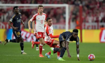 Real Madrid's Vinicius Junior, right, is challenged by Bayern's Jamal Musiala during the Champions League semifinal first leg soccer match between Bayern Munich and Real Madrid at the Allianz Arena in Munich, Germany, Tuesday, April 30, 2024. (AP Photo/Matthias Schrader)