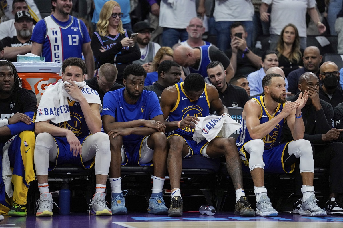 Golden State Warriors guards Klay Thompson, second from left, and Stephen Curry, second from right, sit on the bench during the second half of the team's NBA basketball play-in tournament game against the Sacramento Kings, Tuesday, April 16, 2024, in Sacramento, Calif. (AP Photo/Godofredo A. Vásquez)