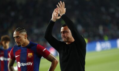 Barcelona's head coach Xavi Hernandez, right, and Barcelona's Raphinha salute supporters at the end of the Champions League quarterfinal second leg soccer match between Barcelona and Paris Saint-Germain at the Olimpic Lluis Companys stadium in Barcelona, Spain, Tuesday, April 16, 2024. (AP Photo/Joan Monfort)