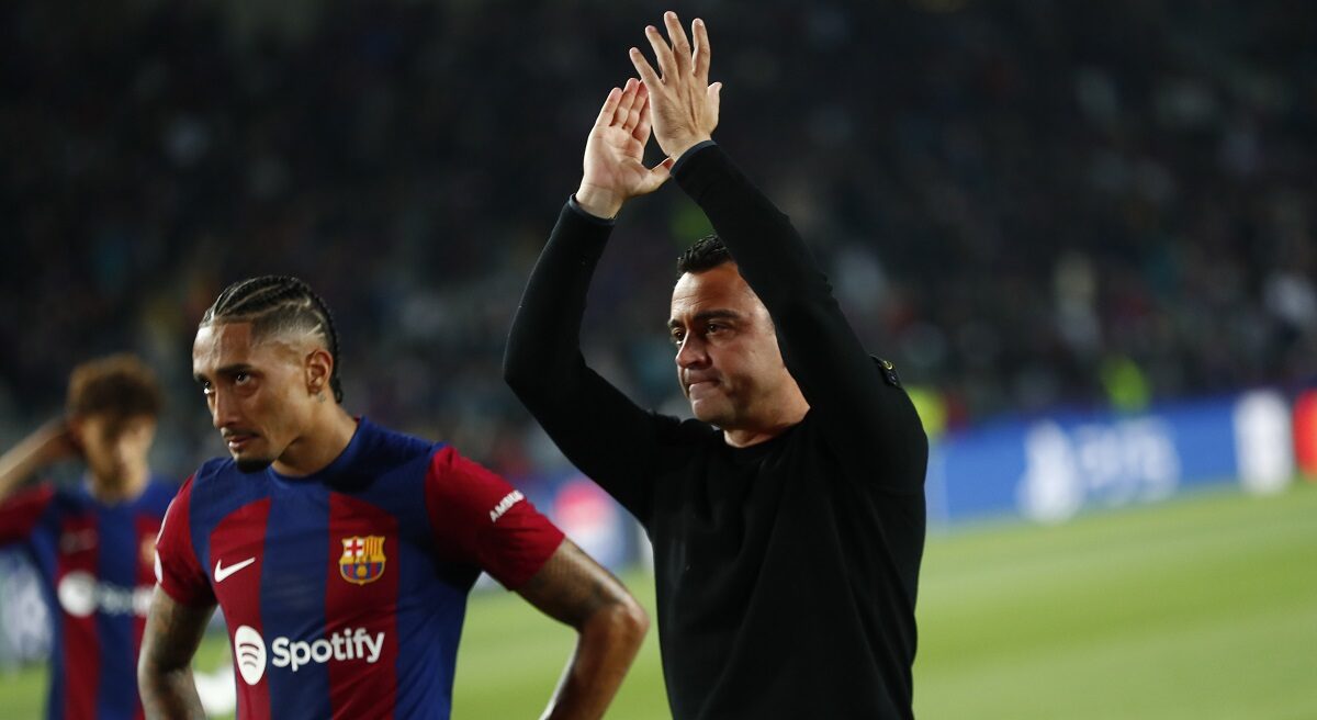 Barcelona's head coach Xavi Hernandez, right, and Barcelona's Raphinha salute supporters at the end of the Champions League quarterfinal second leg soccer match between Barcelona and Paris Saint-Germain at the Olimpic Lluis Companys stadium in Barcelona, Spain, Tuesday, April 16, 2024. (AP Photo/Joan Monfort)