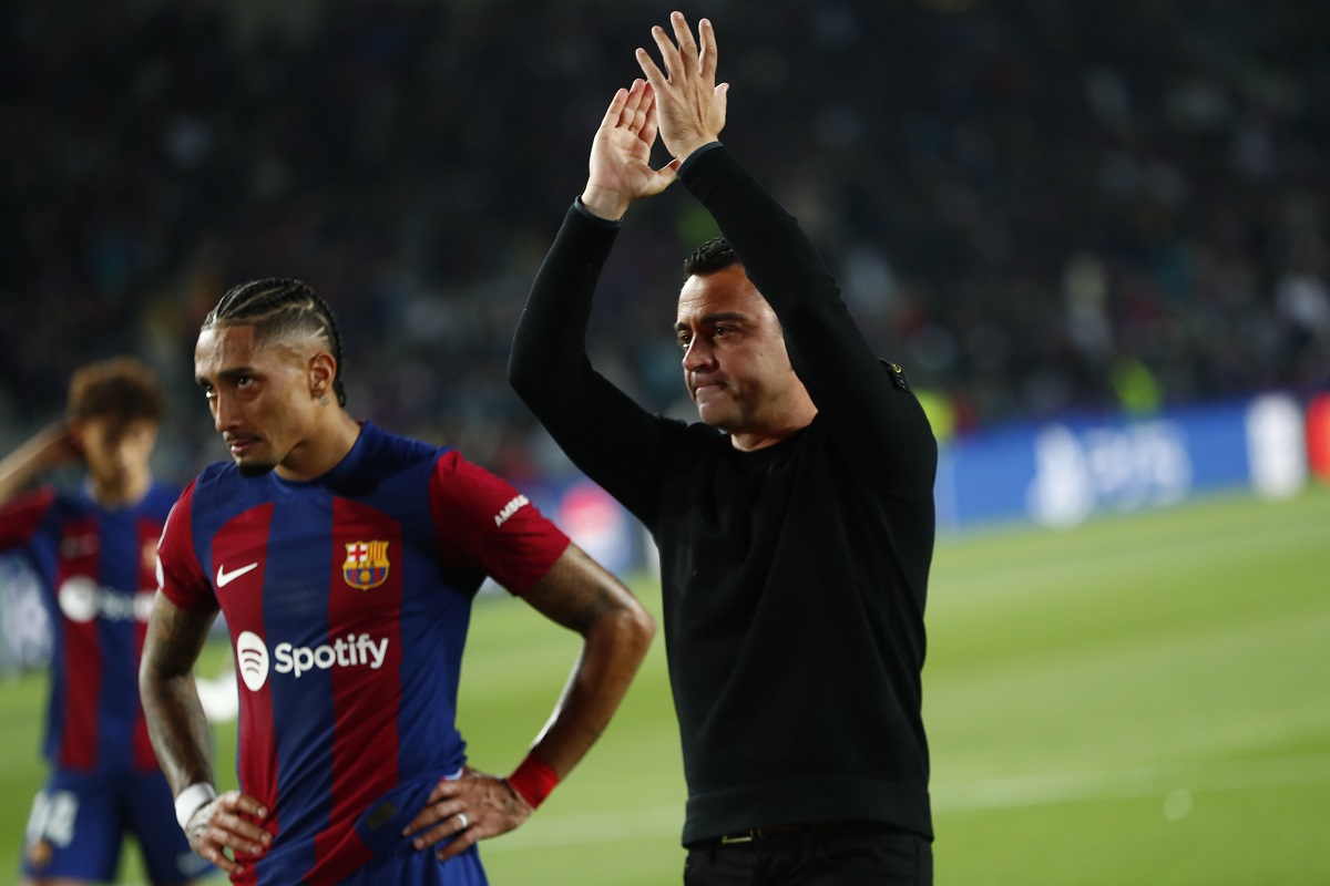 Barcelona's head coach Xavi Hernandez, right, and Barcelona's Raphinha salute supporters at the end of the Champions League quarterfinal second leg soccer match between Barcelona and Paris Saint-Germain at the Olimpic Lluis Companys stadium in Barcelona, Spain, Tuesday, April 16, 2024. (AP Photo/Joan Monfort)