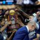 UConn celebrates with the trophy after their win against Purdue in the NCAA college Final Four championship basketball game, Monday, April 8, 2024, in Glendale, Ariz. (AP Photo/David J. Phillip)