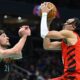 Portland Trail Blazers guard Dalano Banton, right, scores over Washington Wizards forward Corey Kispert during the second half of an NBA basketball game Friday, April 5, 2024, in Washington. (AP Photo/John McDonnell)