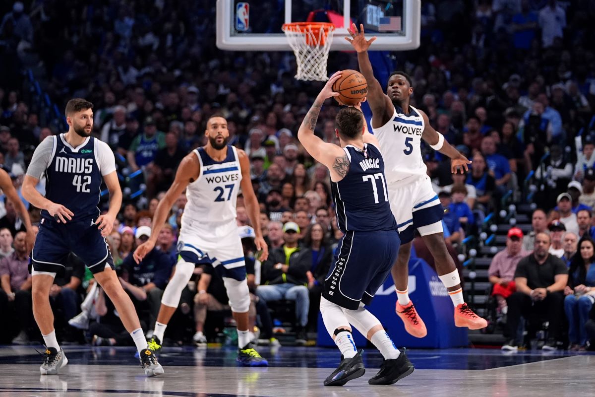 Dallas Mavericks guard Luka Doncic (77) shoots against Minnesota Timberwolves guard Anthony Edwards (5) during the first half in Game 4 of the NBA basketball Western Conference finals, Tuesday, May 28, 2024, in Dallas. (AP Photo/Julio Cortez)