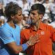 FILE - Serbia's Novak Djokovic hugs Spain's Rafael Nadal, left, after winning the quarterfinal match of the French Open tennis tournament in three sets, 7-5, 6-3, 6-1, at Roland Garros stadium, in Paris, France, Wednesday, June 3, 2015. There have been 59 installments of Nadal vs. Djokovic, more than between any two other men in the Open era of tennis, which dates to 1968. Djokovic leads 30-29 overall. (AP Photo/David Vincent, File)