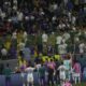 Fiorentina players try to deescalated during their supporters clashes with police at the half time during the Conference League final soccer match between Olympiacos FC and ACF Fiorentina at OPAP Arena in Athens, Greece, Wednesday, May 29, 2024. (AP Photo/Petros Karadjias)