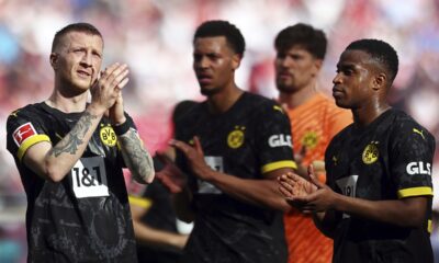 From left, Dortmund's players Marco Reus, Felix Nmecha, Gregor Kobel and Youssoufa Moukoko applaud after the German Bundesliga soccer match between RB Leipzig and Borussia Dortmund in Leipzig, Germany, Saturday, April 27, 2024. (Jan Woitas/dpa via AP)