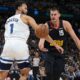 Minnesota Timberwolves forward Kyle Anderson, left, battles for control of the ball with Denver Nuggets center Nikola Jokic, right, in the first half of Game 2 of an NBA basketball second-round playoff series Monday, May 6, 2024, in Denver. (AP Photo/David Zalubowski)